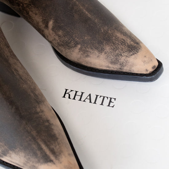 Brown pointed-toe boots with 'KHAITE' branding on a white background
