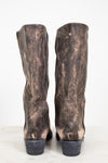 Pair of distressed brown leather boots on a white background