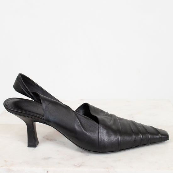 Pair of black leather slingback heels on a light background