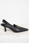 Pair of black leather slingback heels on a light background