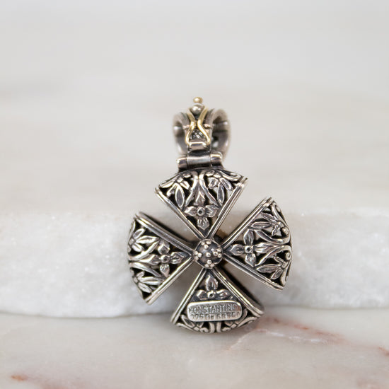 Back view of silver cross pendent on white background