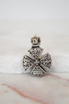 Back view of silver cross pendent on white background