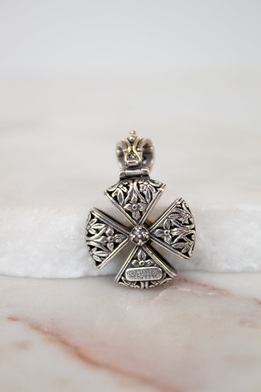 Back view of silver cross pendent on white background
