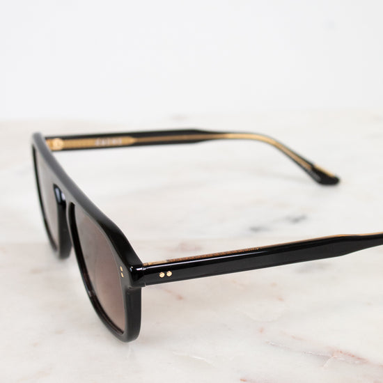 Black sunglasses on a marble surface
