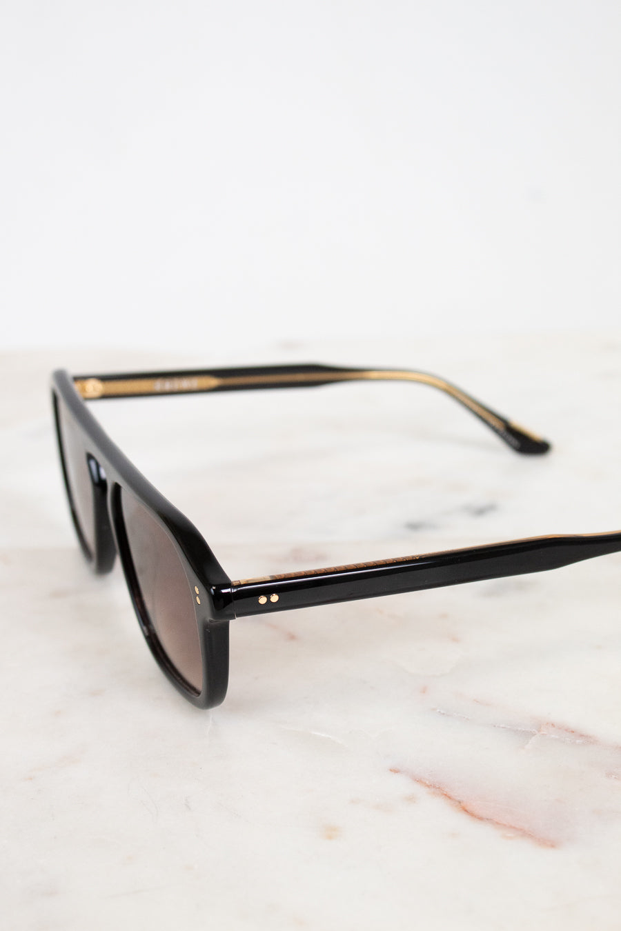 Black sunglasses on a marble surface