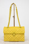 Yellow quilted handbag with chain strap on a white background