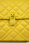 Yellow quilted handbag with a visible Kurt Geiger brand logo on a light background