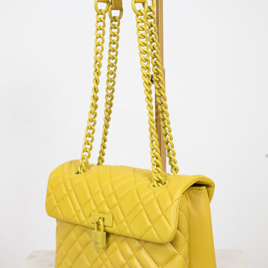 Yellow quilted handbag with chain strap on a white background