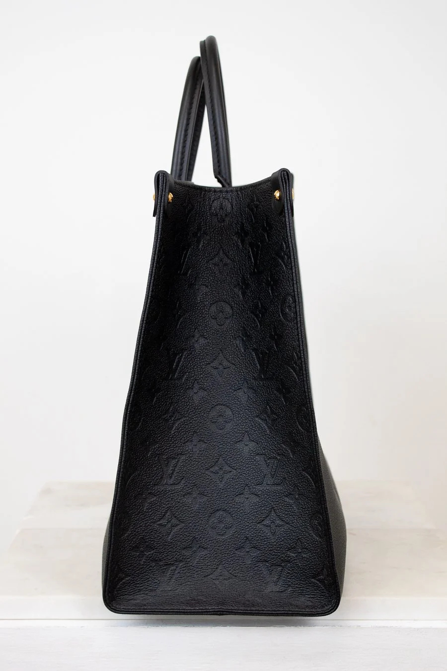 Black textured handbag on a white background
