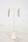 Jewelry stand with necklaces on a marble surface