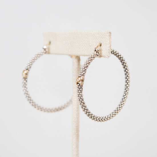 Silver hoops with gold accent on white background