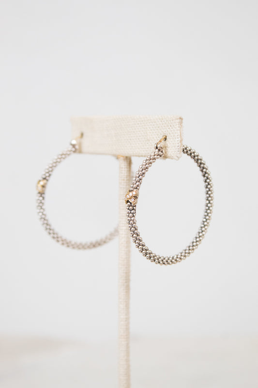 Silver hoops with gold accent on white background