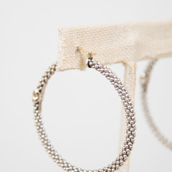 Silver hoop earrings on a white background