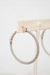 Silver hoop earrings on a white background