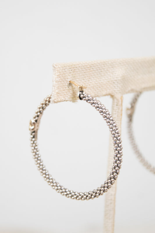 Silver hoop earrings on a white background
