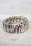Silver beaded bracelet with a clasp on a light background