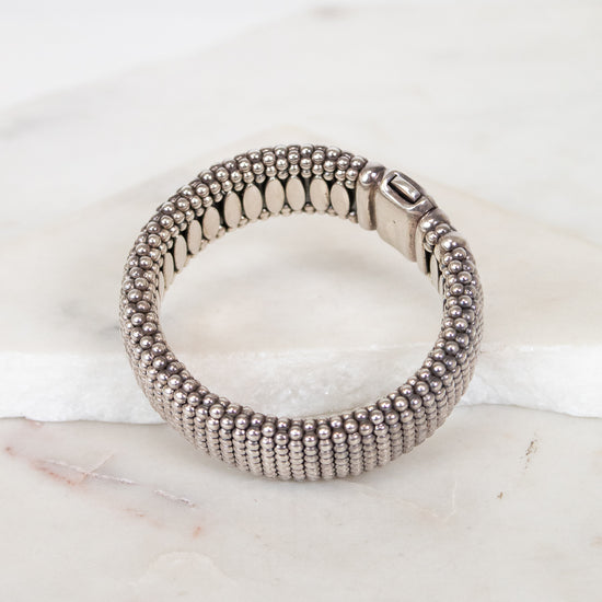 Silver beaded bracelet on a marble surface