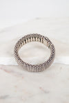 Silver beaded bracelet on a marble surface