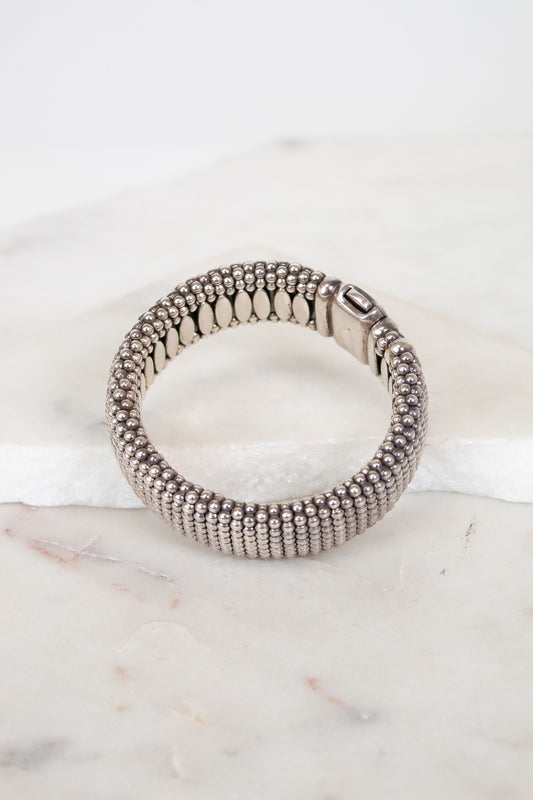 Silver beaded bracelet on a marble surface