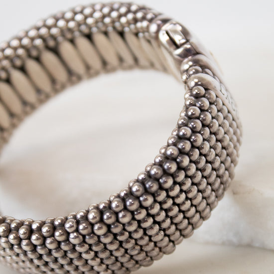 Silver beaded bracelet on a light background