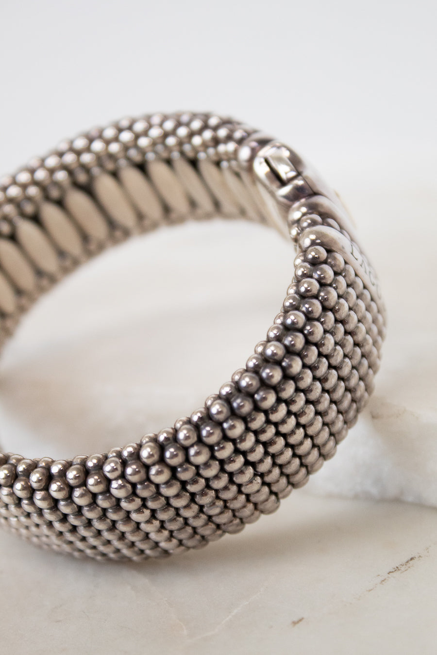 Silver beaded bracelet on a light background