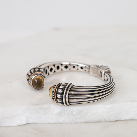 Silver bracelet with gemstone on a white surface