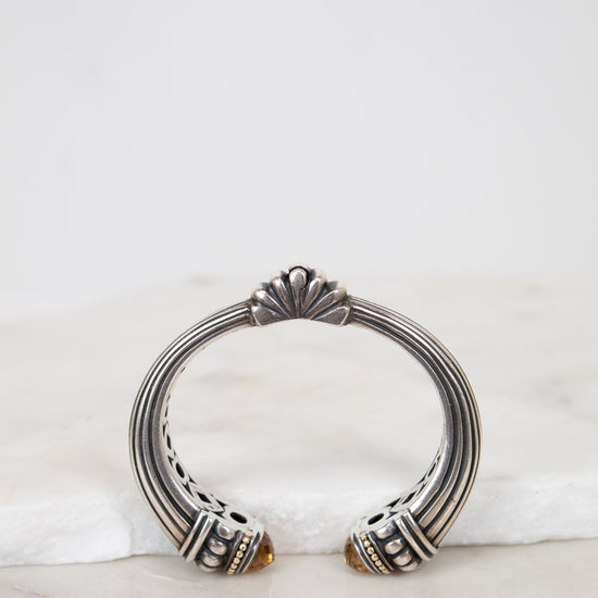 Silver bracelet with decorative elements on a marble surface
