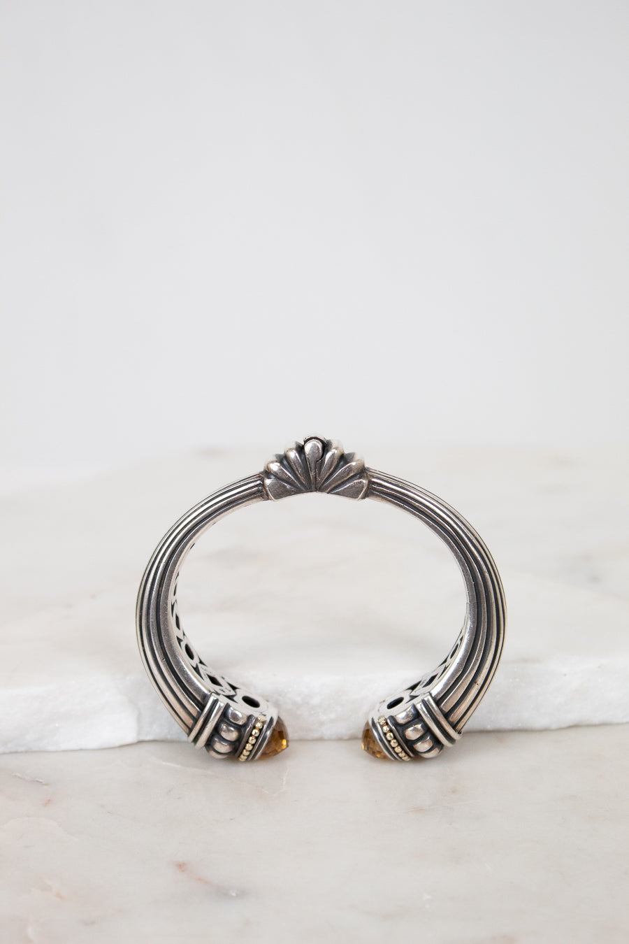 Silver bracelet with decorative elements on a marble surface