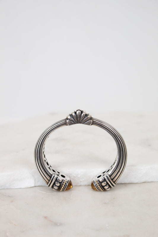 Silver bracelet with decorative elements on a marble surface