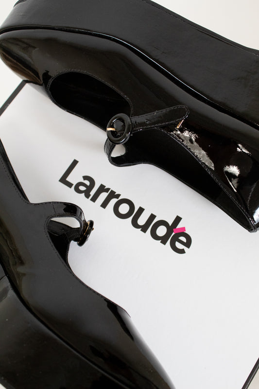 Close-up of a black and white product with 'Larroude' branding on a white background