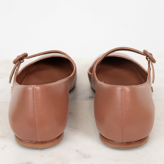 Pair of brown leather shoes on a marble surface