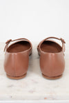 Pair of brown leather shoes on a marble surface