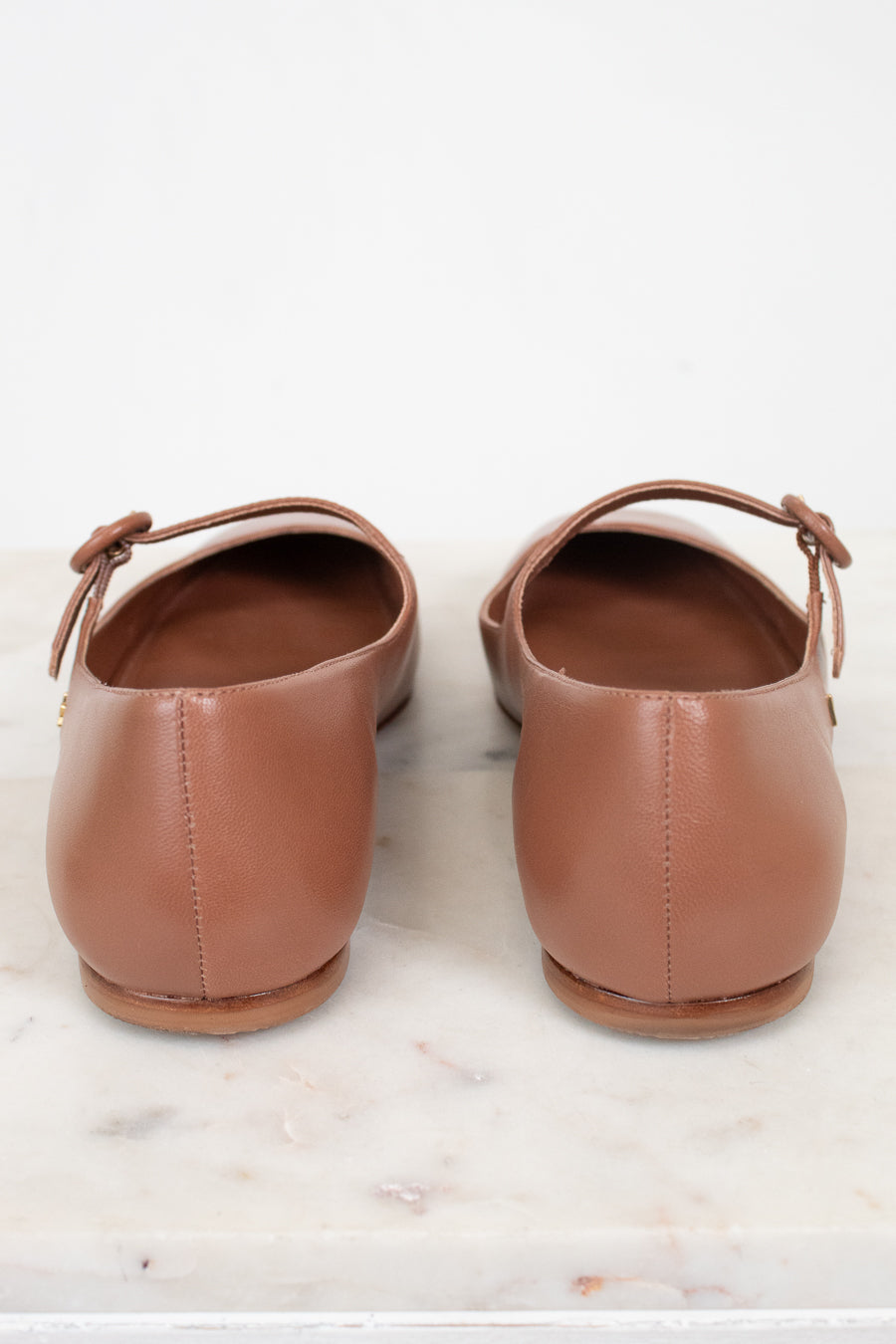 Pair of brown leather shoes on a marble surface