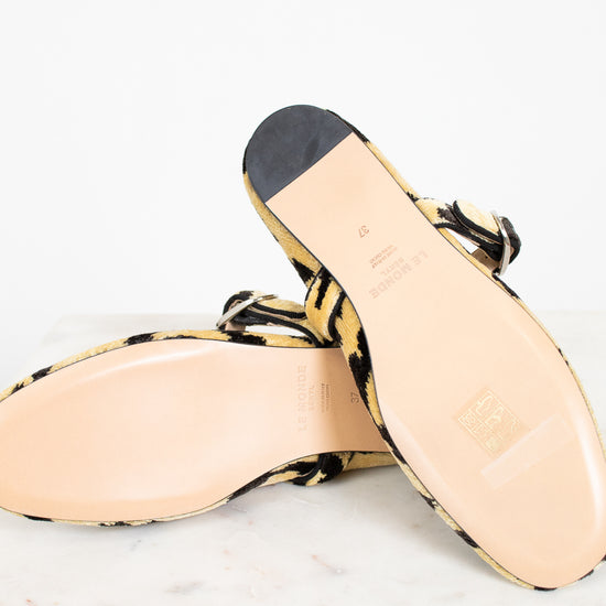 Sole of a pair leopard print shoes on a white background