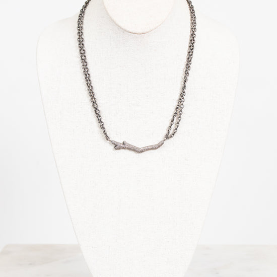Necklace on a mannequin against a white background
