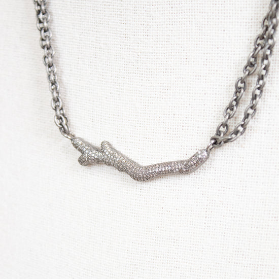 Necklace with a branch-like pendant on a white background