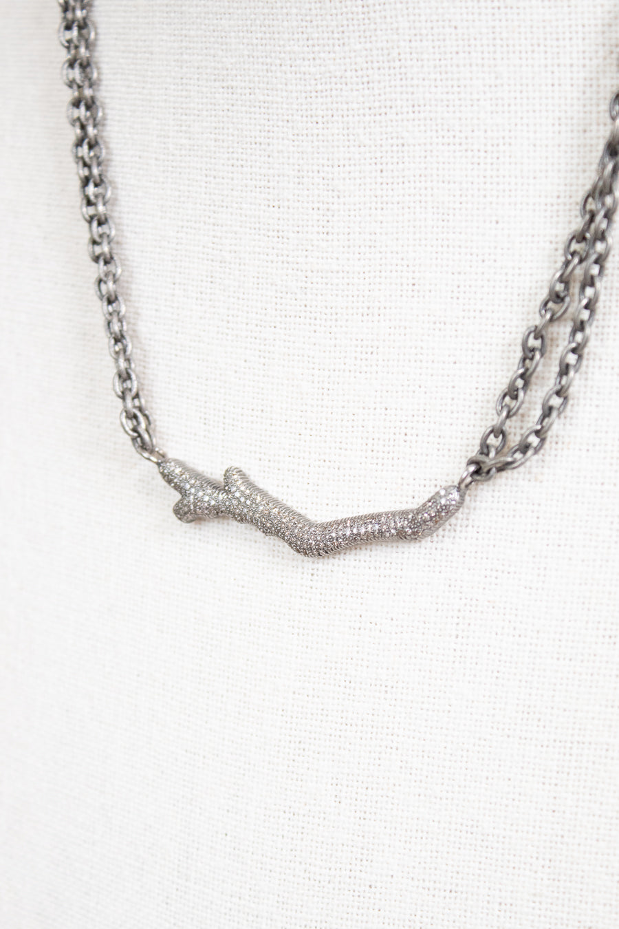 Necklace with a branch-like pendant on a white background