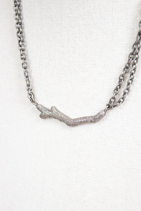 Necklace with a branch-like pendant on a white background