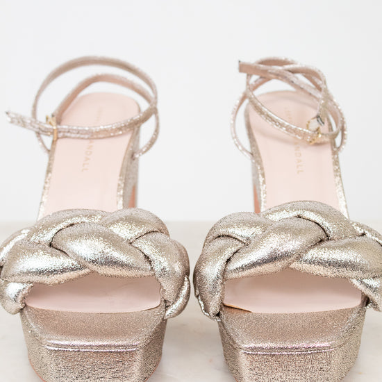 Pair of silver glitter high-heeled shoes on a white background
