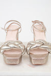 Pair of silver glitter high-heeled shoes on a white background