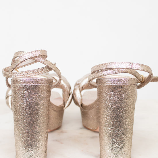 Pair of glittery high-heeled shoes on a white background