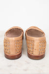 Pair of tan loafer shoes with wooden soles on a white background