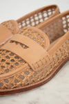 Tan woven sandal on a light background