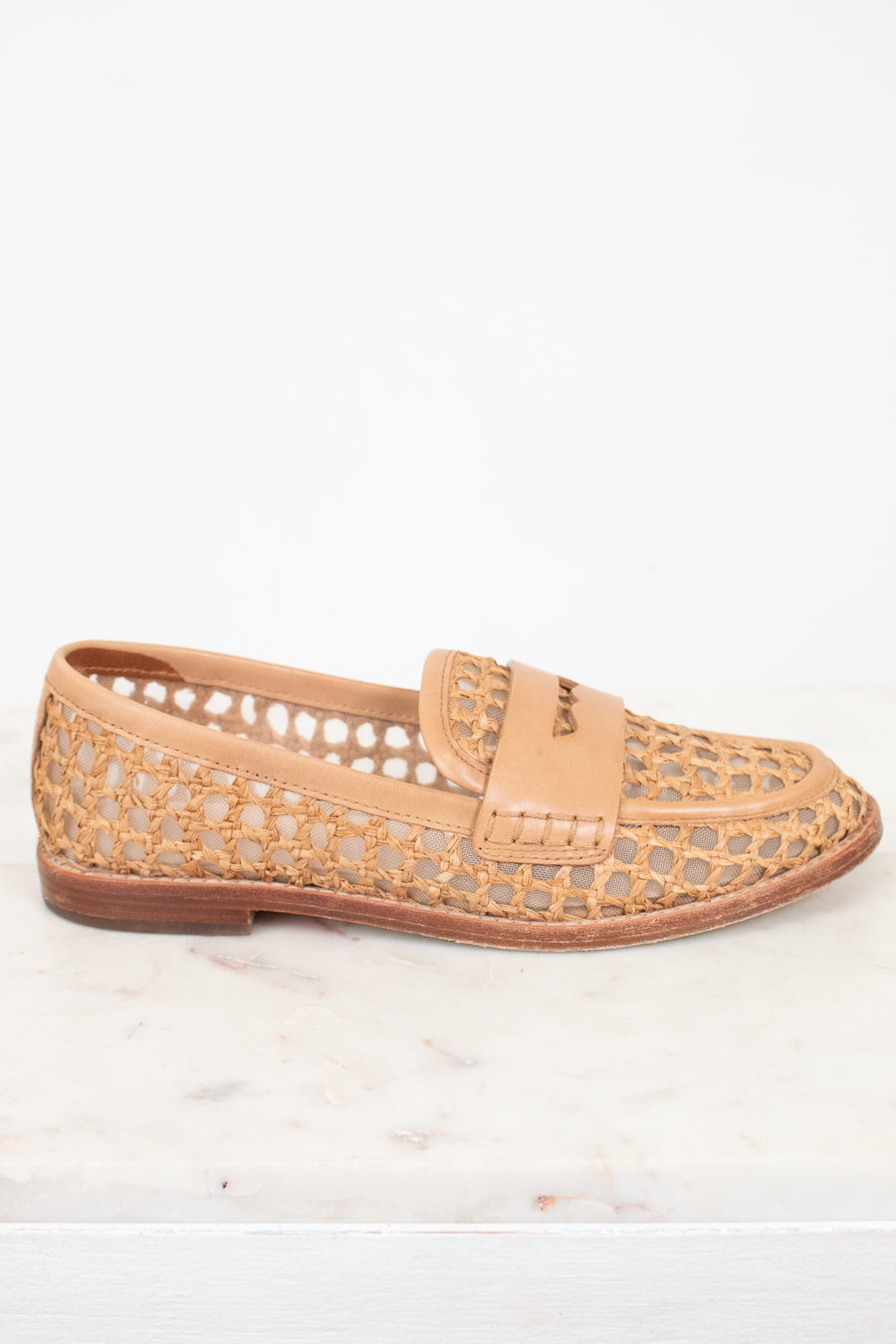 Tan woven loafer shoe on a white background.