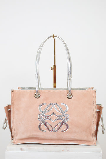 Pink handbag with a silver logo on a white background