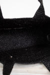 Close-up of black textured handbag interior on a white background