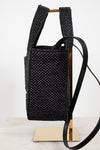 Black woven handbag with a strap on a white background