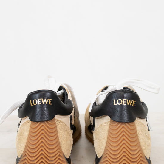 Pair of Loewe shoes with black soles on a light background
