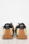 Pair of Loewe shoes with black soles on a light background