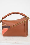 Brown handbag with a braided handle on a white background